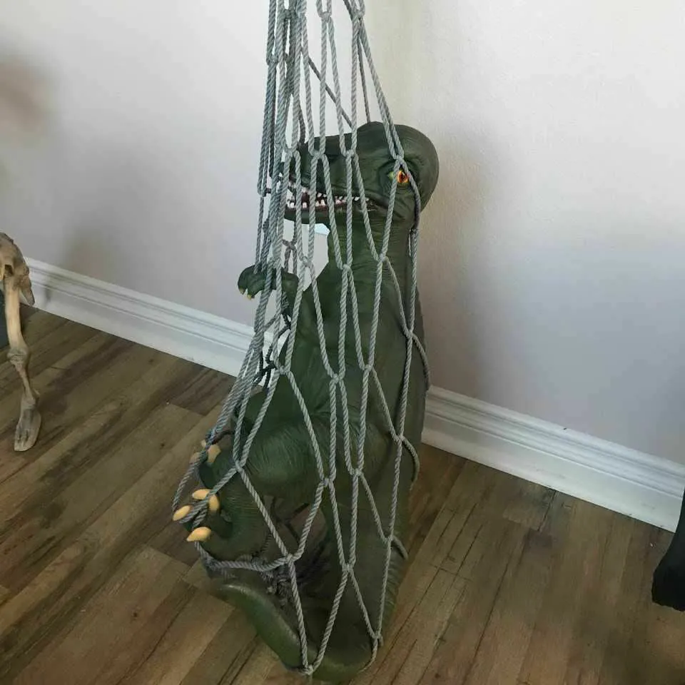 Baby T-Rex Dinosaur In Net Life Size Statue