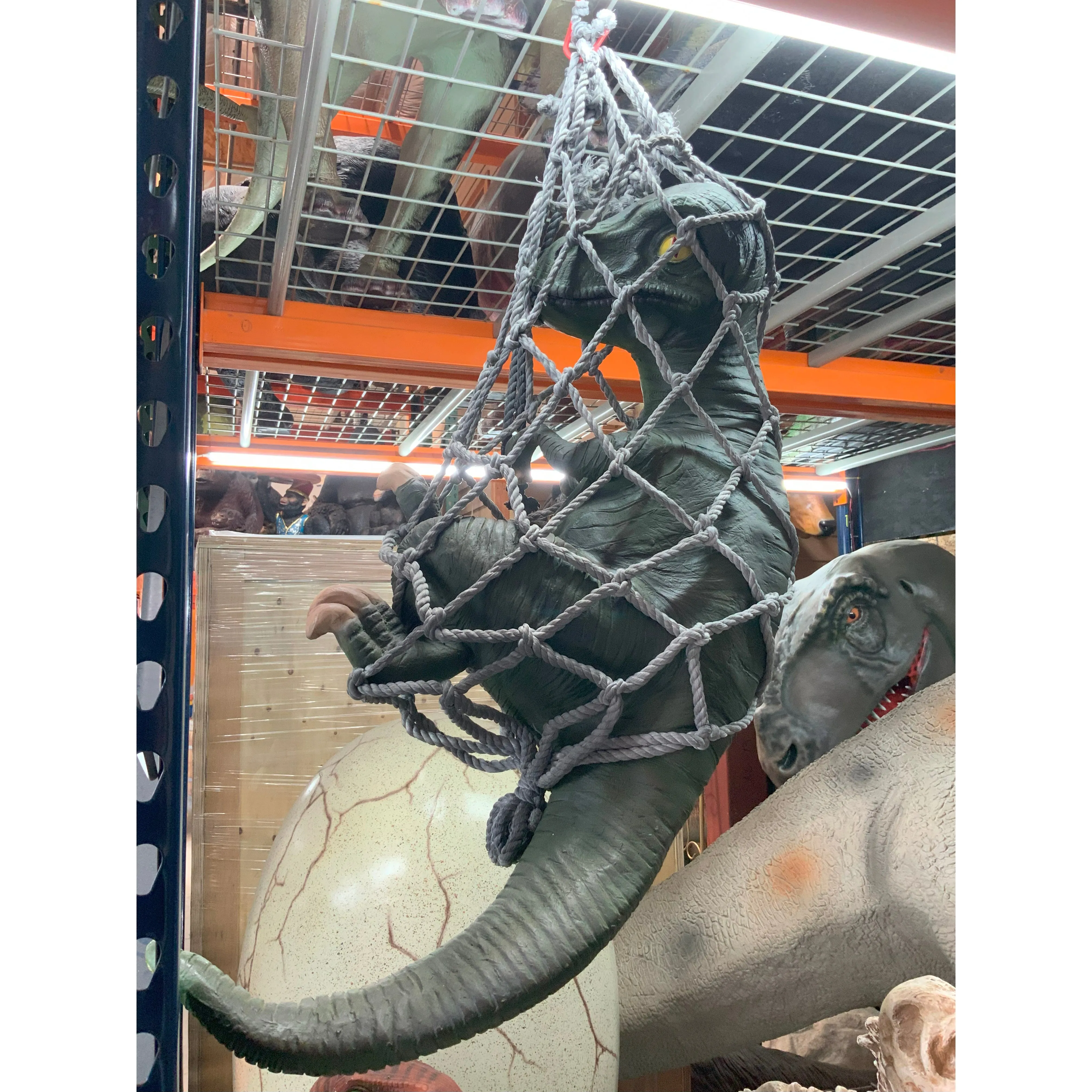 Baby T-Rex Dinosaur In Net Life Size Statue