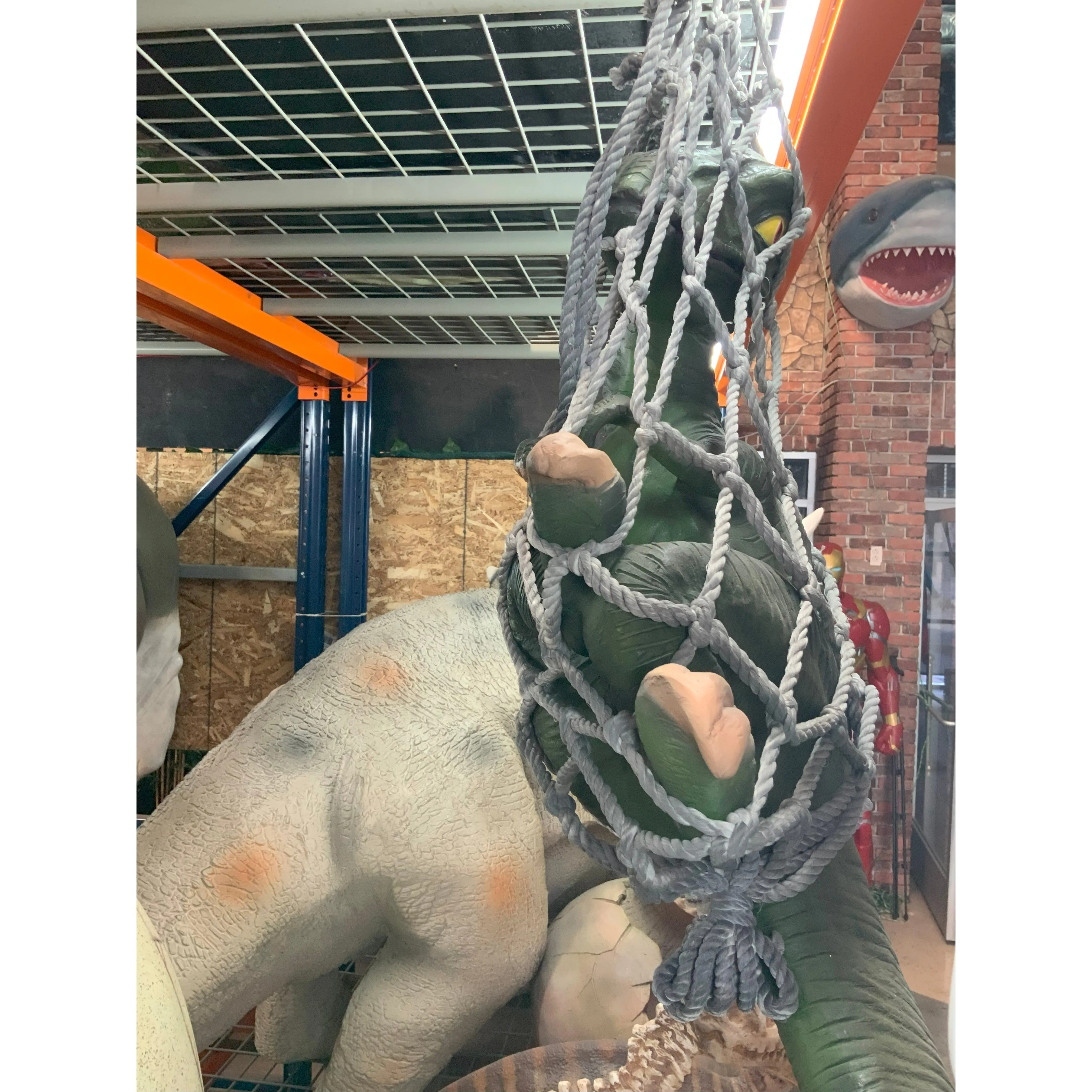 Baby T-Rex Dinosaur In Net Life Size Statue